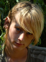 Naked blonde teen boy posing in the garden