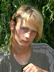 Naked blonde teen boy posing in the garden