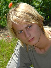 Naked blonde teen boy posing in the garden