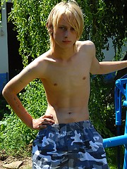Naked blonde teen boy posing in the garden