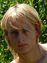 Naked blonde teen boy posing in the garden