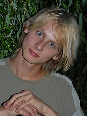 Naked blonde teen boy posing in the garden